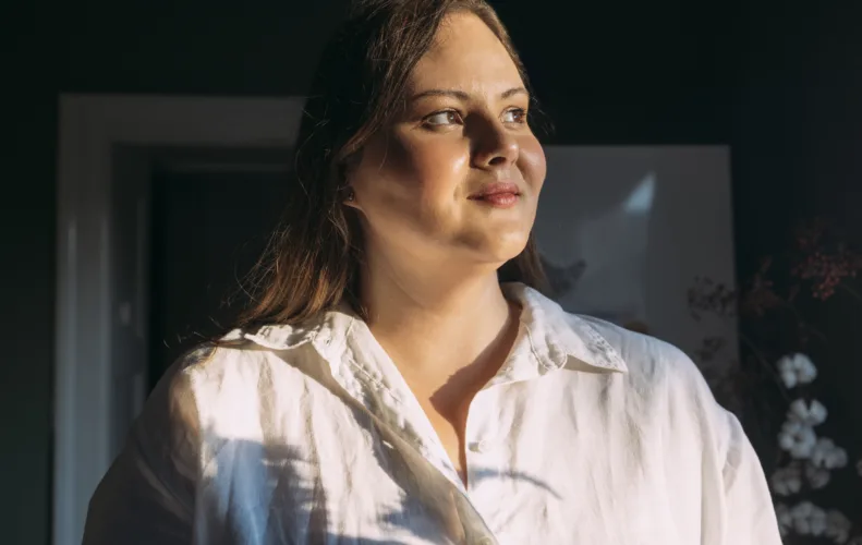 A portrait of a beautiful Caucasian overweight female baker looking away